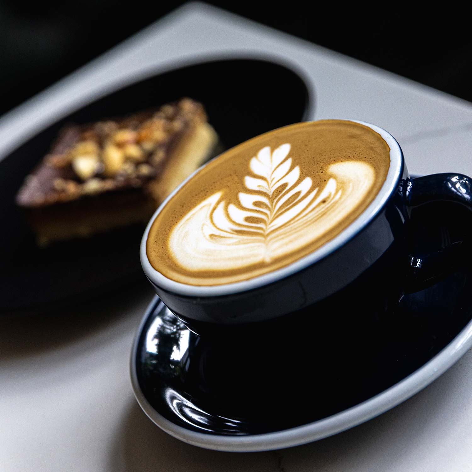 A stack of grilled sandwiches filled with various ingredients on a wooden board.