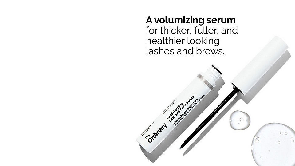 A volumizing serum from 'The Ordinary' for enhancing lashes and brows, alongside the applicator and clear droplets.
