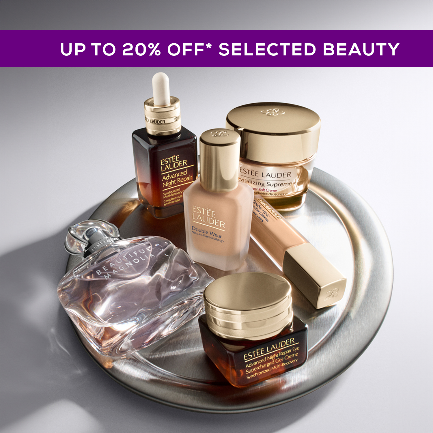 Luxury skincare and fragrance products displayed on silver tray, including serums, moisturisers, and perfume bottle