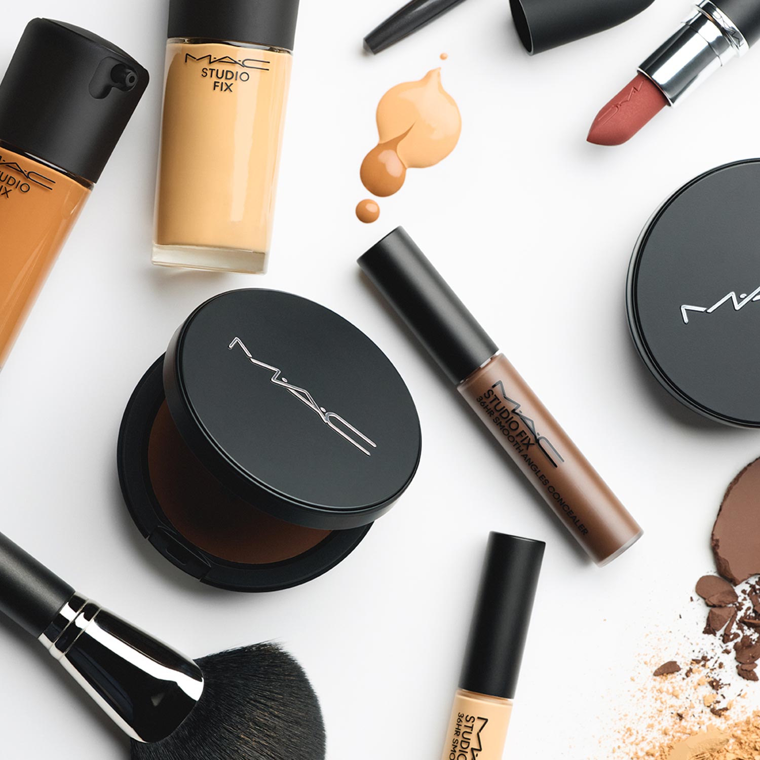 M.A.C makeup products including eyeshadow palette, liquid eyeliner, and makeup brushes on white background