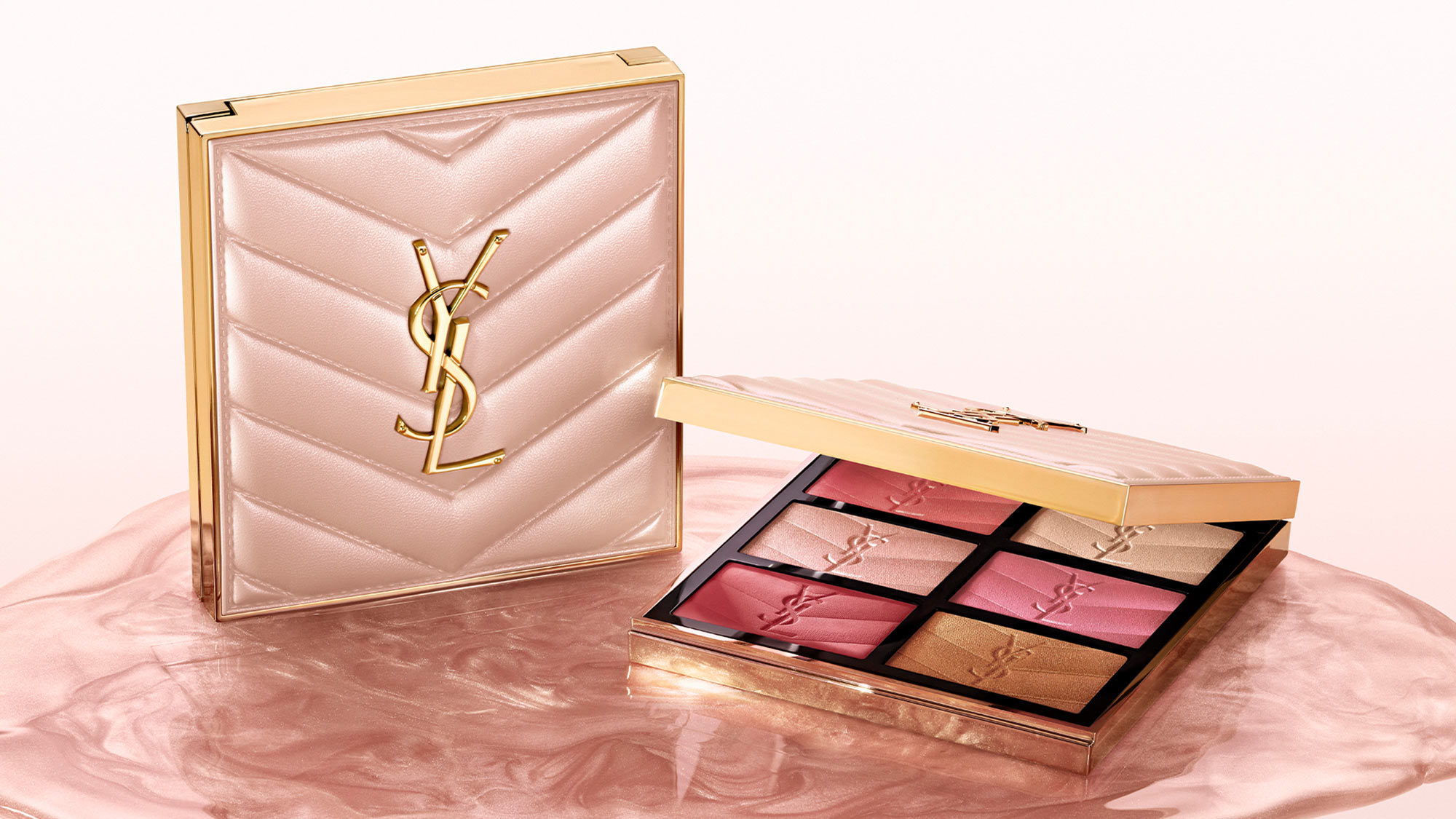 A makeup palette with six shades, next to a matching quilted case featuring a gold logo, on a pink marbled surface.