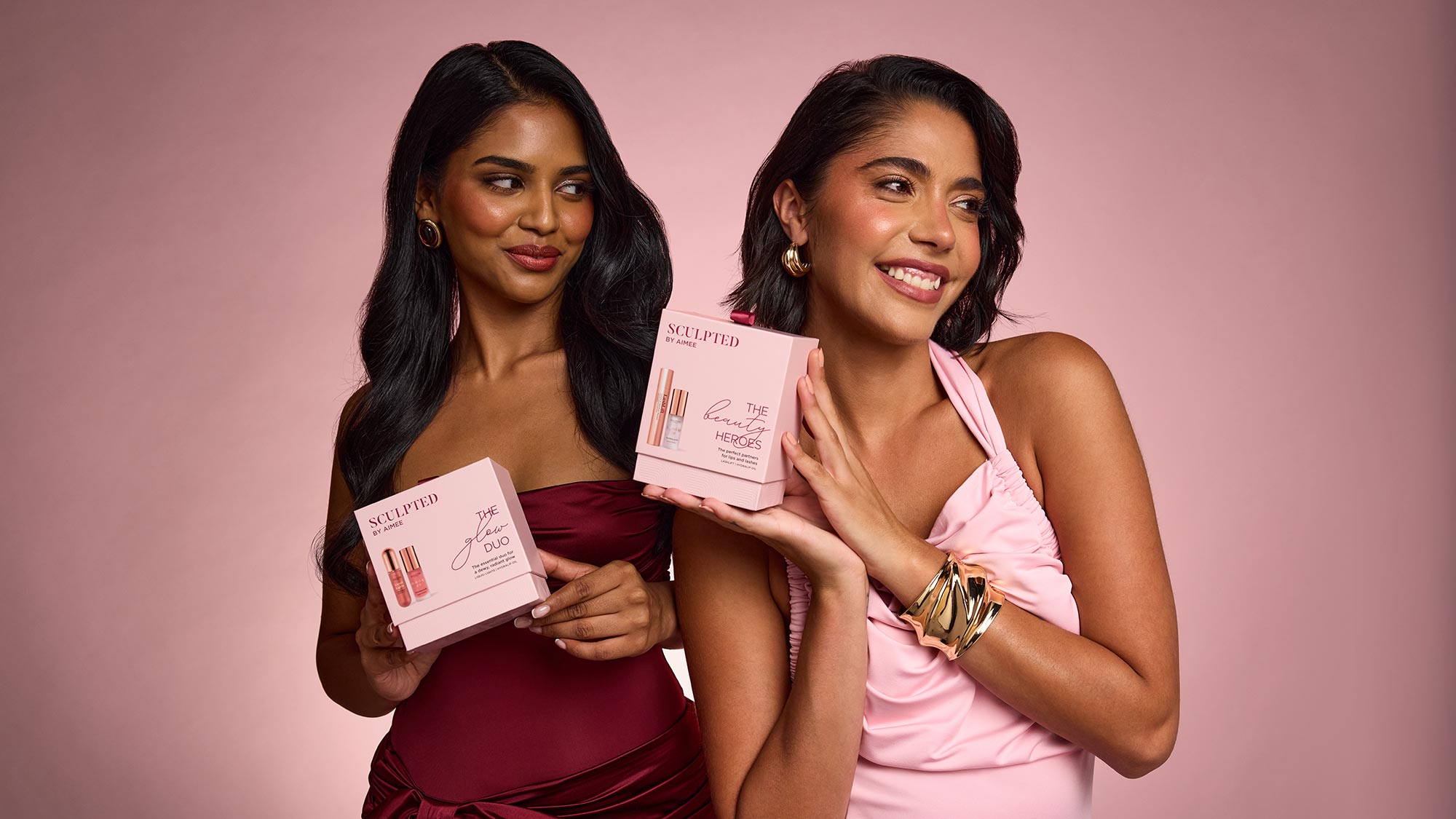 sculpted by aimee skincare gift sets with two models holding