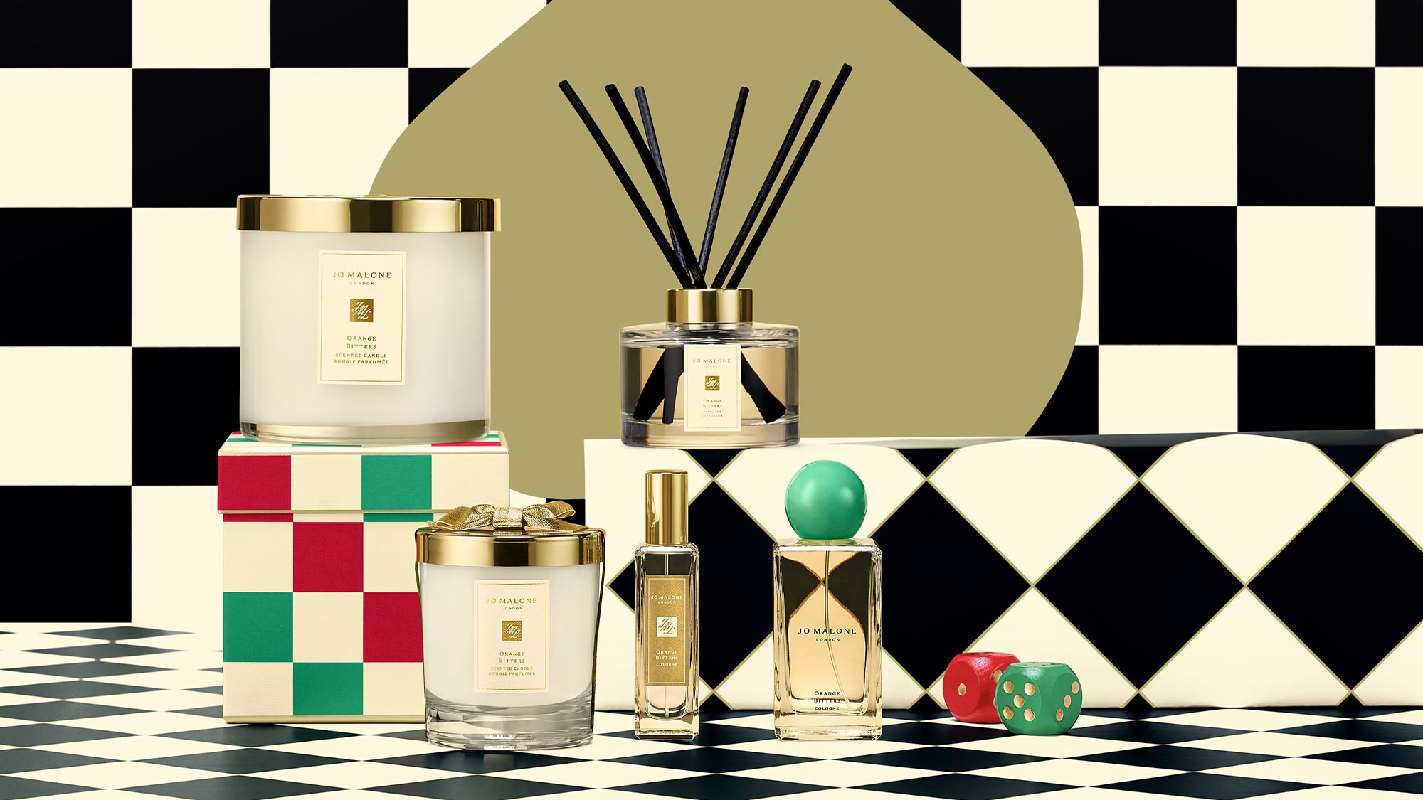 Candles, perfumes, and reed diffusers on a checkered surface with a black and white checkered background, featuring colorful geometric elements.