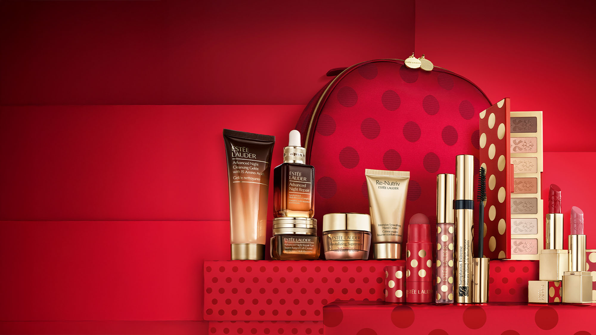 A red-themed makeup and skincare set, including creams, lipsticks, and an eyeshadow palette, displayed with a matching patterned bag.