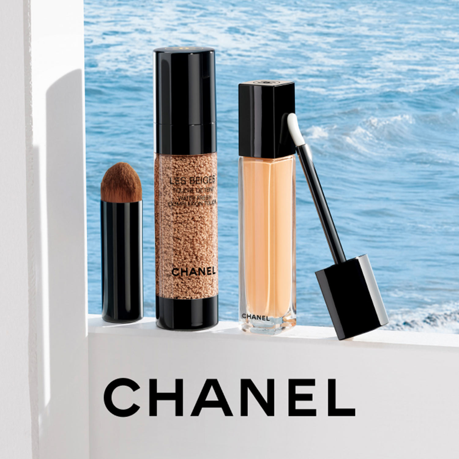 Chanel Les Beiges collection makeup products including brush, foundation, and liquid cosmetics with ocean backdrop