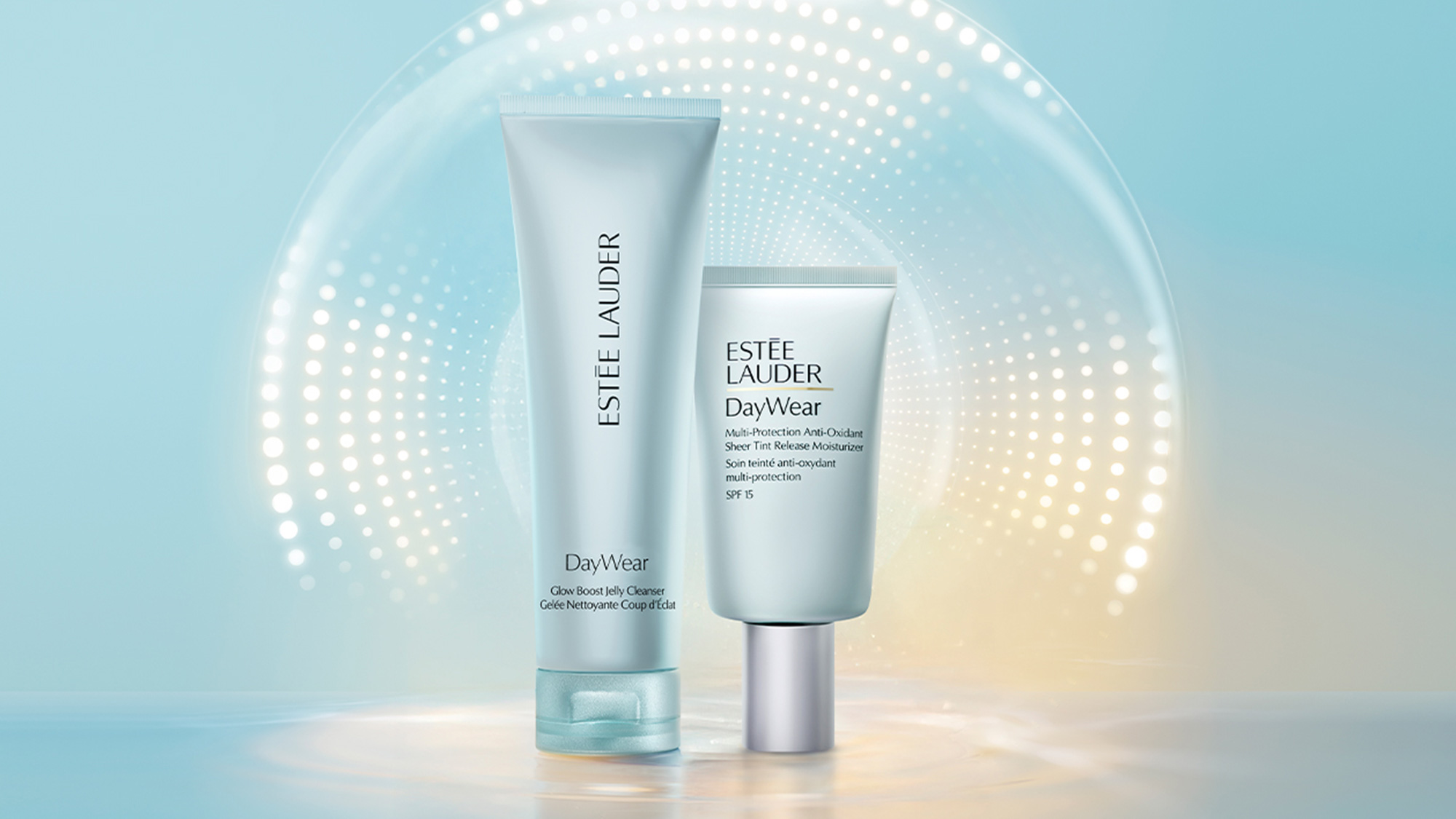 Estée Lauder DayWear skincare collection featuring Glow Boost Jelly Cleanser and multi-protection moisturiser with SPF 15 on gradient background