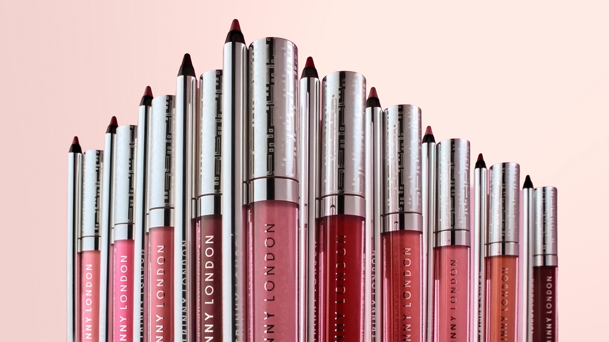 Trinny London Lip Reset collection displaying multiple lip products in varying shades from nude to deep burgundy