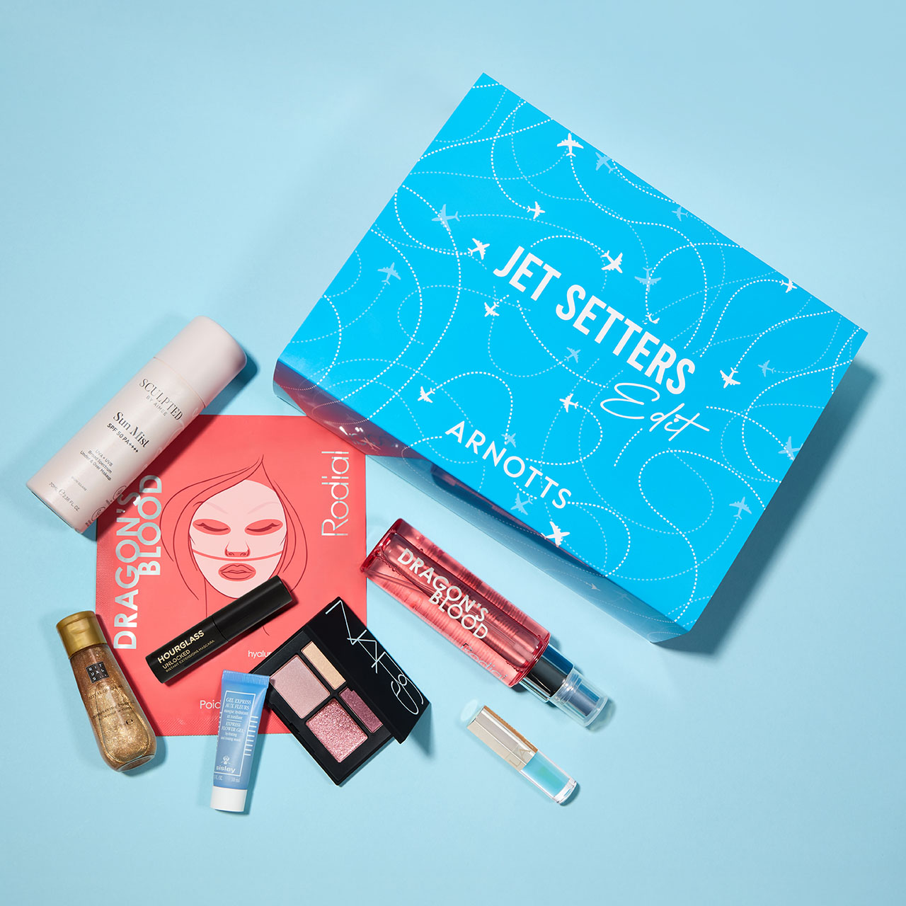 The Jet Setters Edit beauty box worth &euro;200, containing cosmetics and skincare products, displayed on blue background with white circle showing value