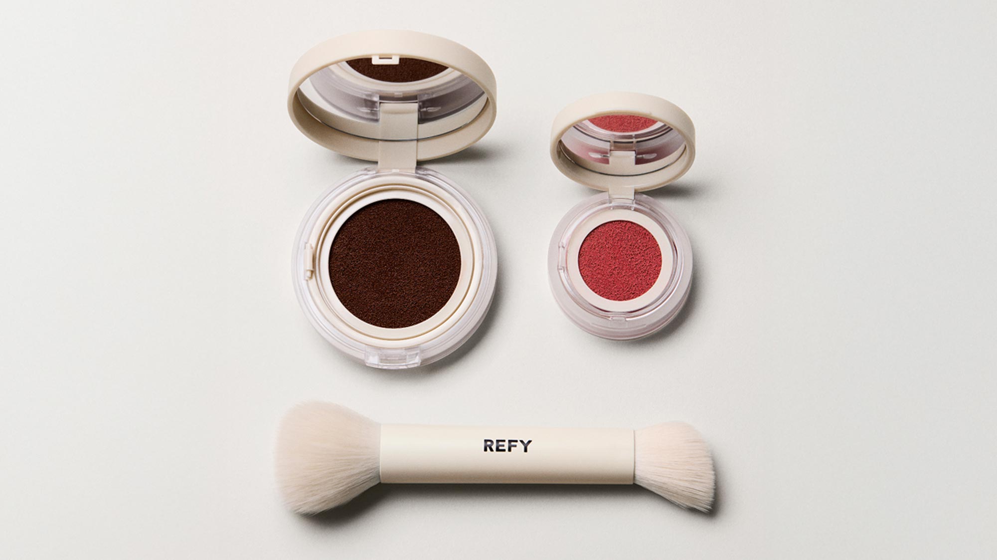 REFY Water Blush and Bronzer set with cream-coloured compact containers in chocolate brown and coral red shades, plus dual-ended brush