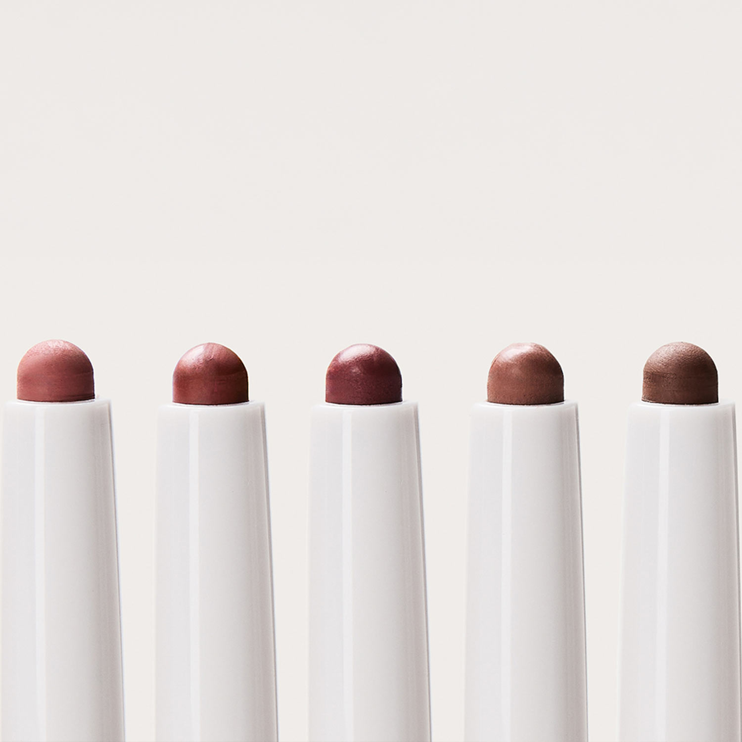 Seven REFY Blur Liner pencils in varying shades from dusty rose to deep brown, displayed in a row showing colour range