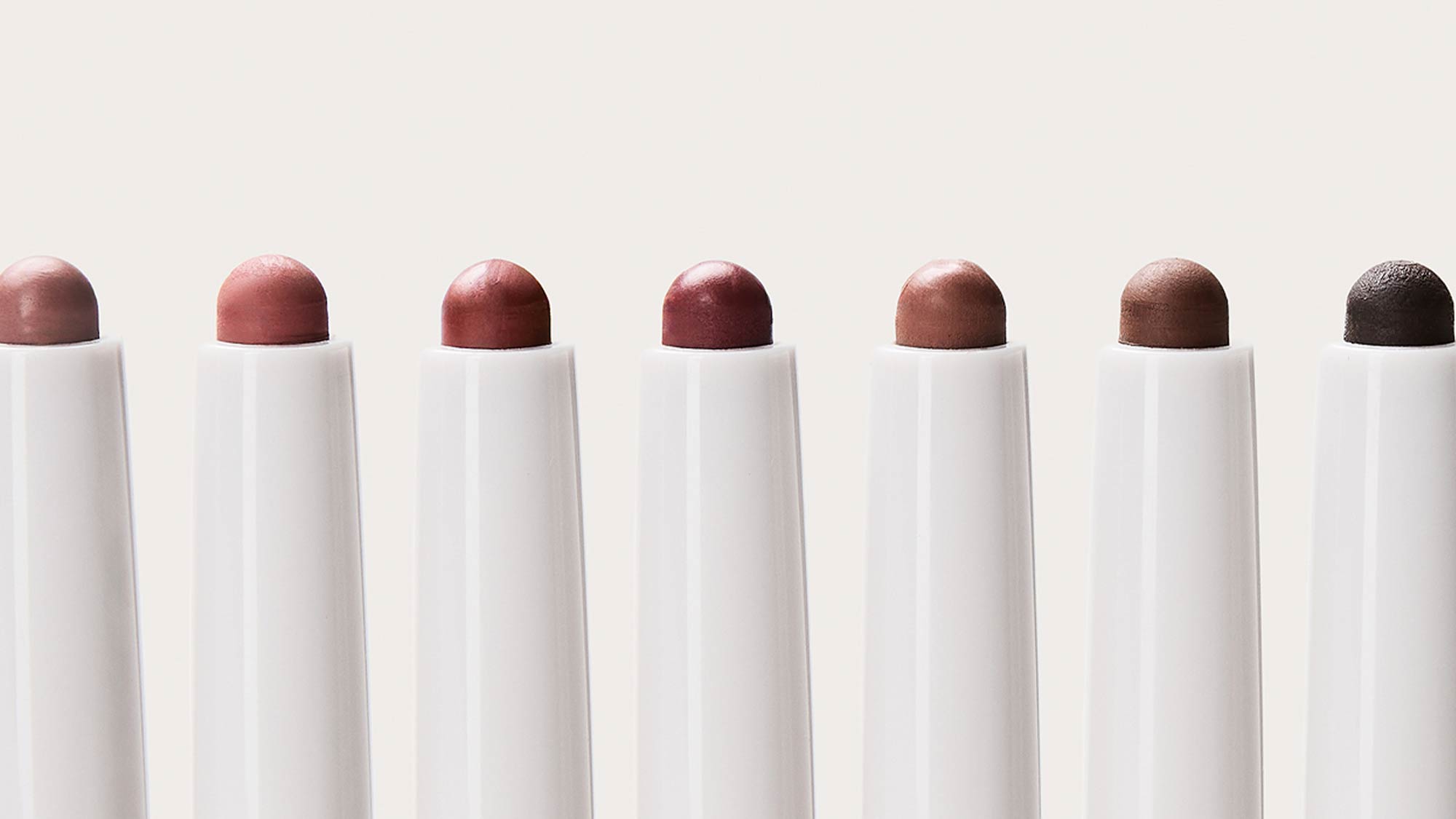 Seven REFY Blur Liner pencils in varying shades from dusty rose to deep brown, displayed in a row showing colour range