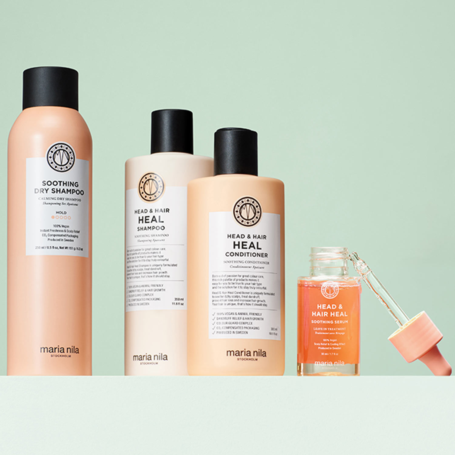 Maria Nila haircare collection including soothing dry shampoo, head and hair heal shampoo and conditioner, and soothing serum on pale green background