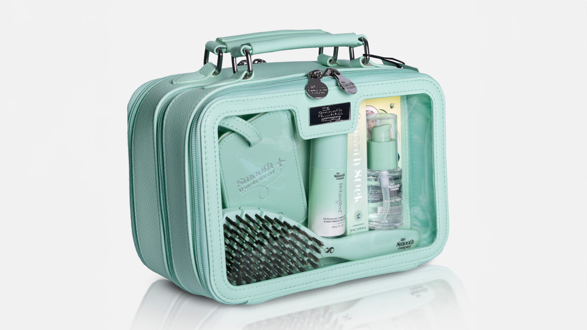 The Smooth Company Smoothcase travel bag in mint green containing haircare products, brush, and accessories