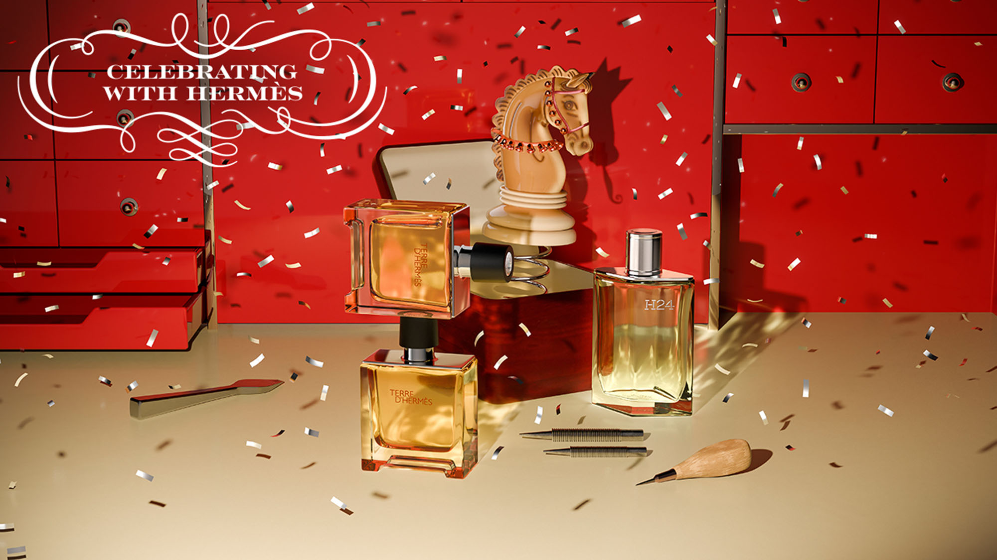 Celebratory display of Hermès fragrances and accessories on red background with confetti, golden horse sculpture, and decorative brushes
