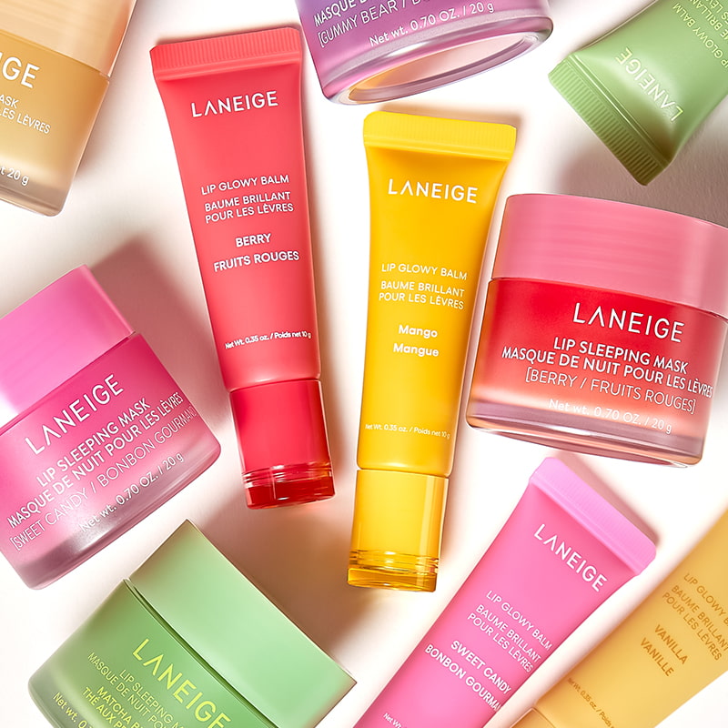Various LANEIGE lip care products, including balms and masks, in colorful tubes and jars, are arranged on a light surface.
