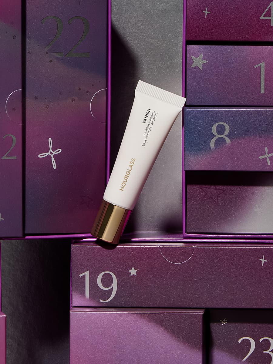 A tube of Hourglass cosmetics is placed among numbered purple boxes with star patterns.