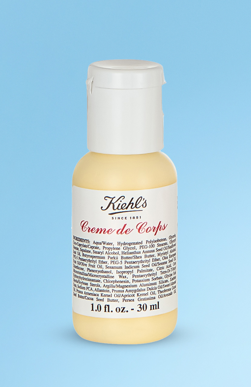 A small bottle of Kiehl's Creme de Corps lotion, 1.0 fl. oz (30 ml), with an ingredient list on the label.