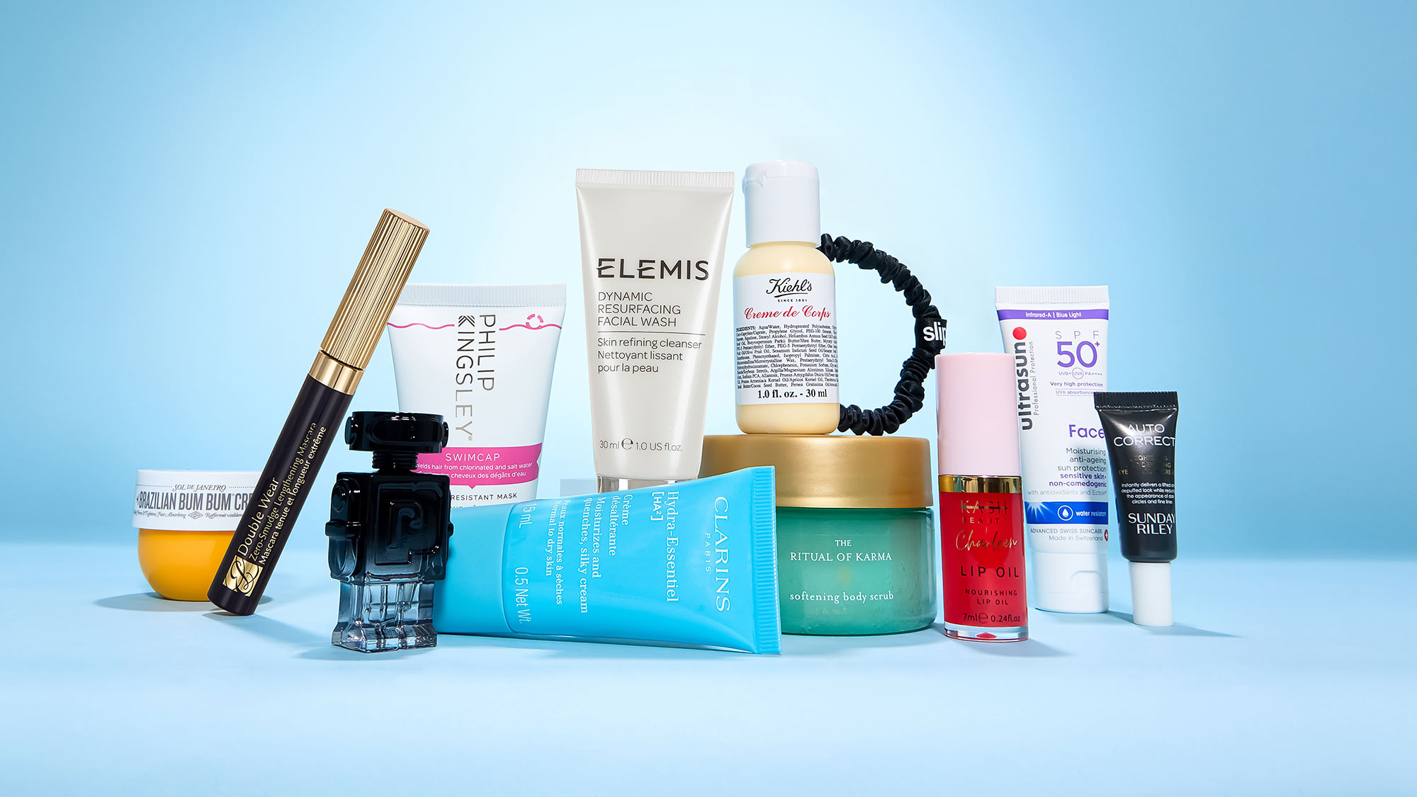 A variety of skincare and beauty products arranged on a light beige background.