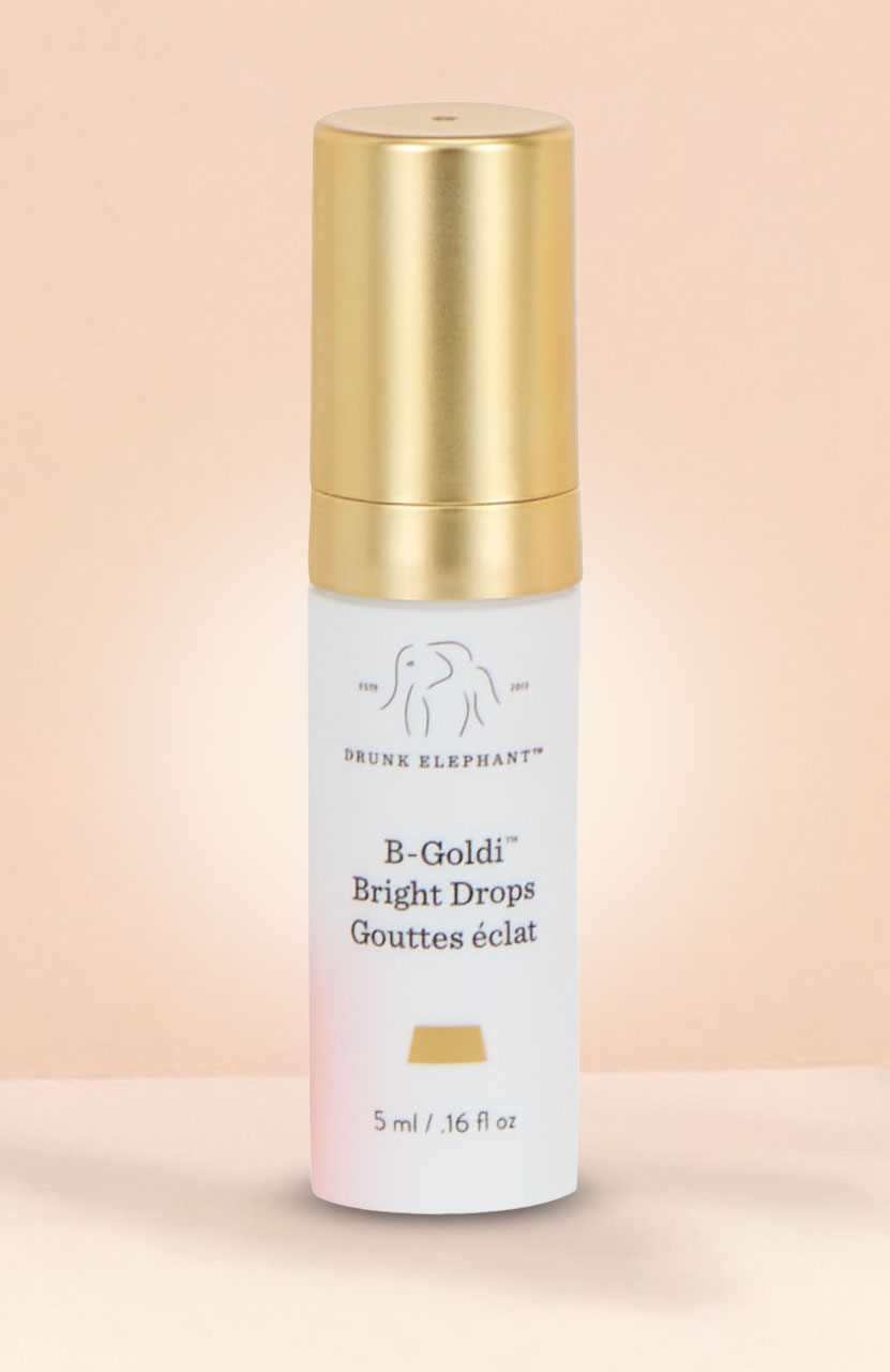 A dark blue bottle of Oribe Mirror Rinse Gloss Hair Treatment with a pointed applicator cap.