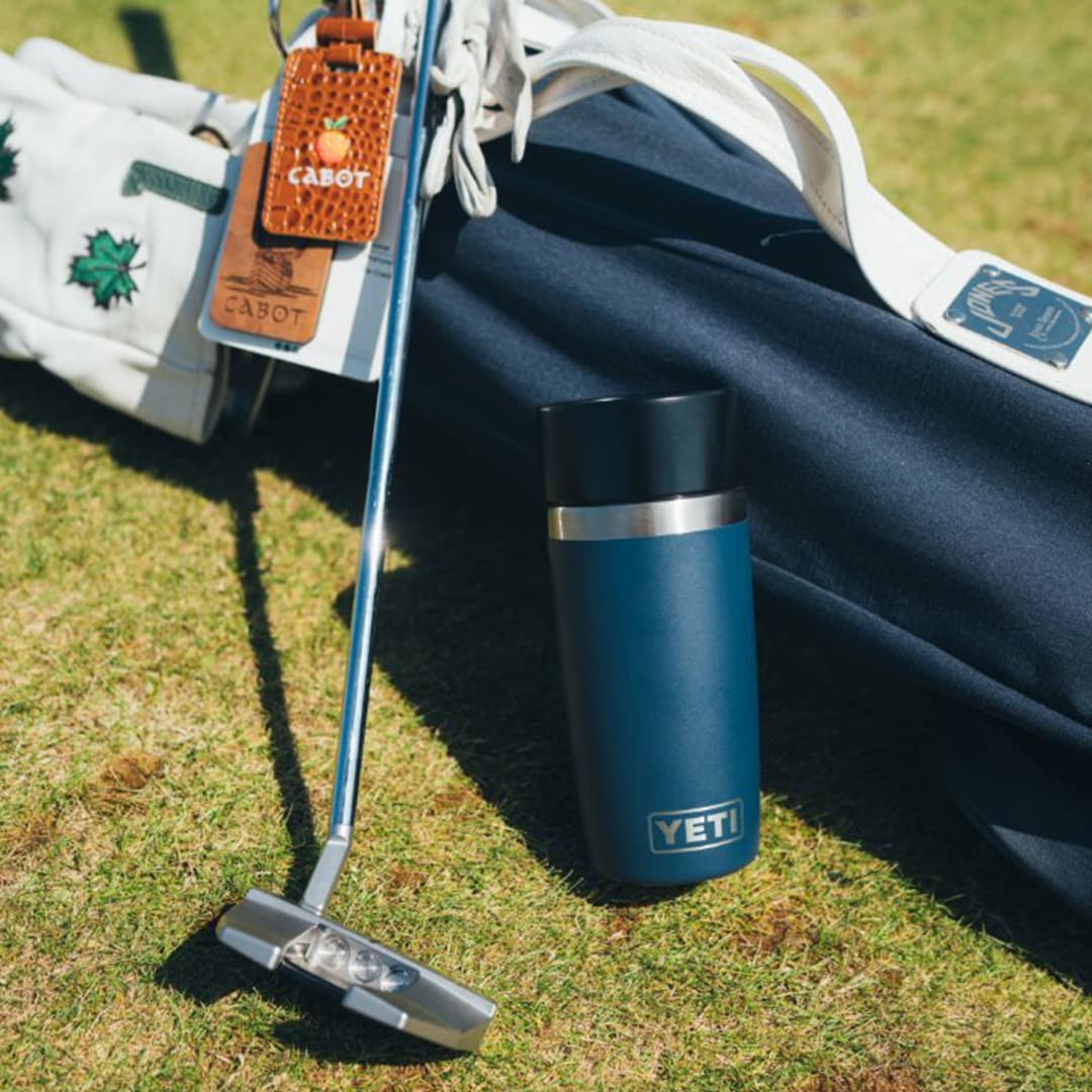 Hydration essentials for golf including YETI and Stanley water bottles and sleek hip flask for keeping drinks cool during long rounds