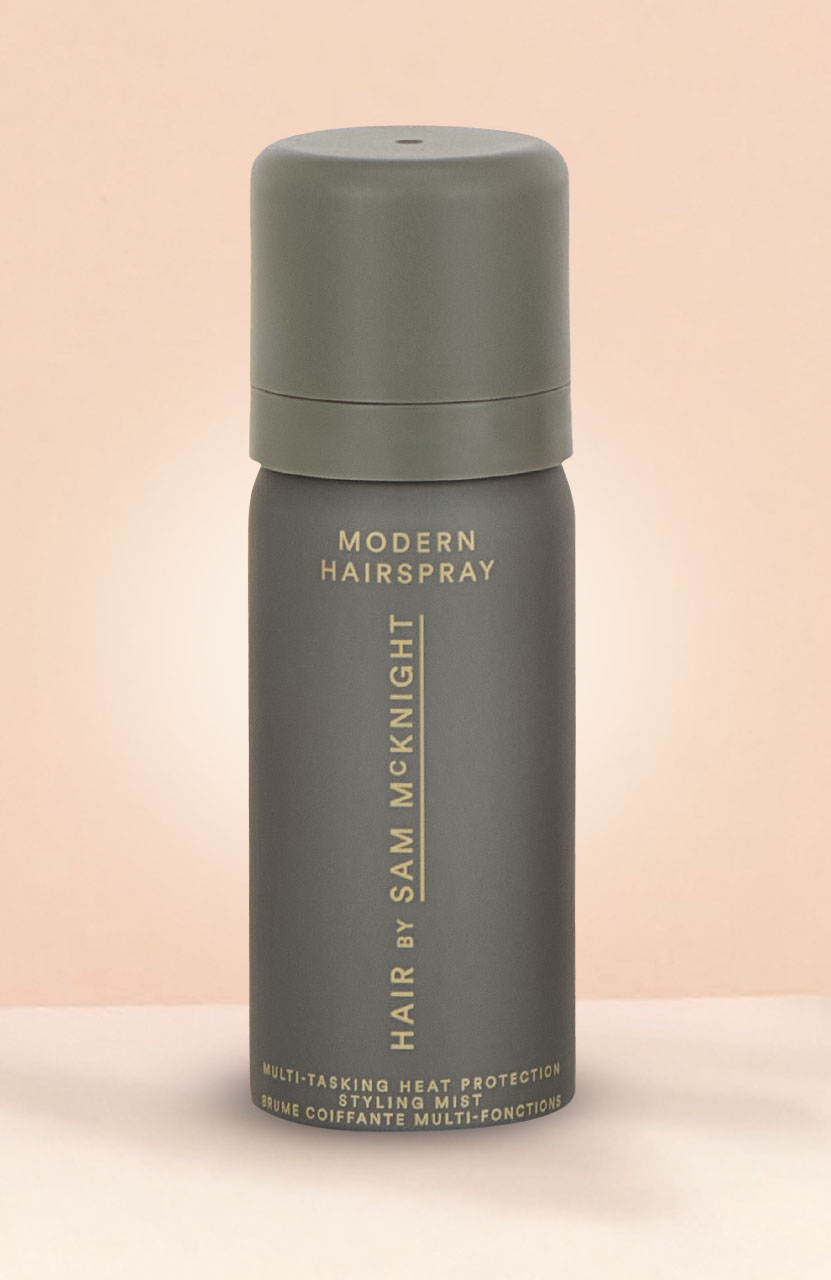 Black and gold mascara tube with text 'Double Wear' on a blue background.