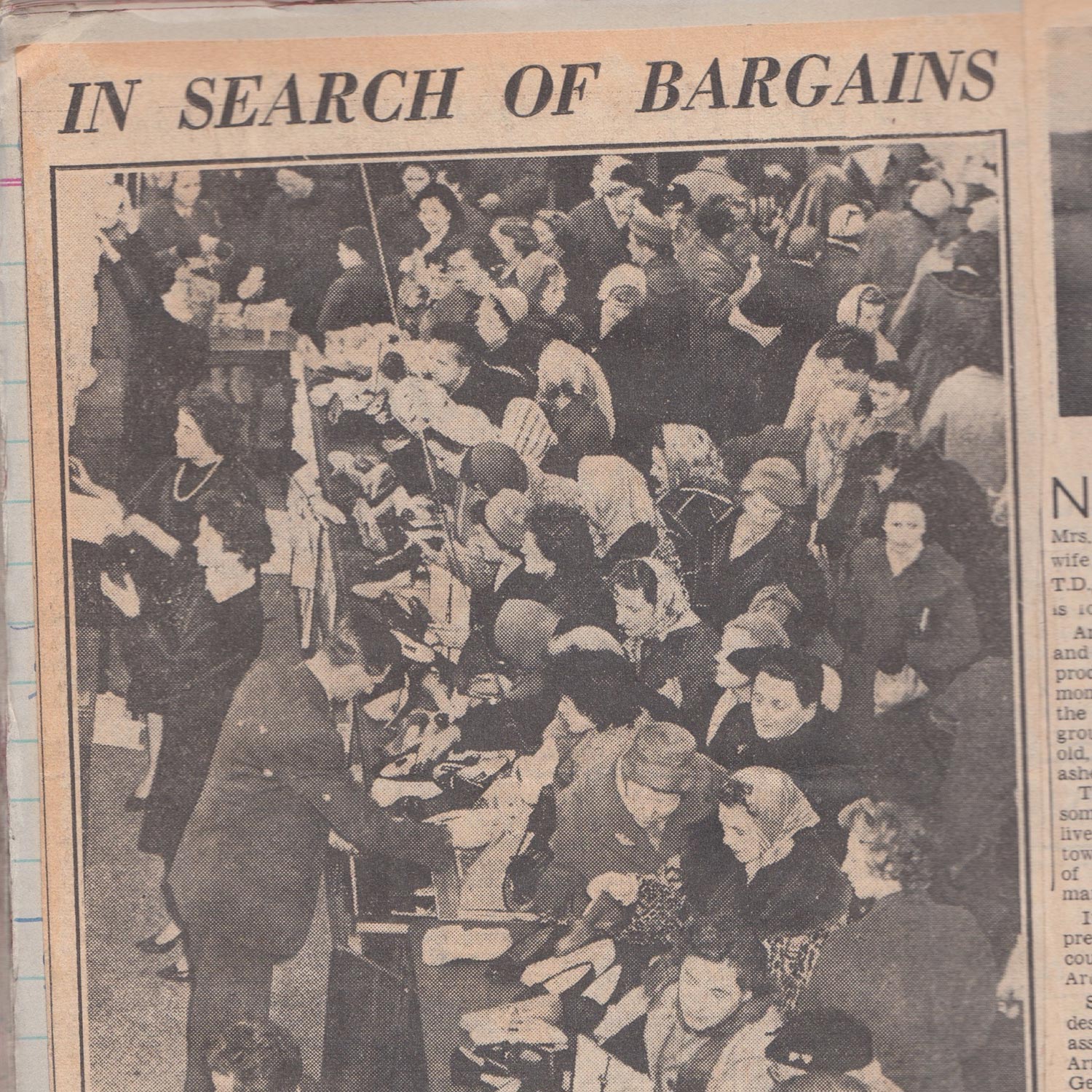 Black and white photograph showing a large crowd of women shopping, titled 'In Search of Bargains', from 1912.