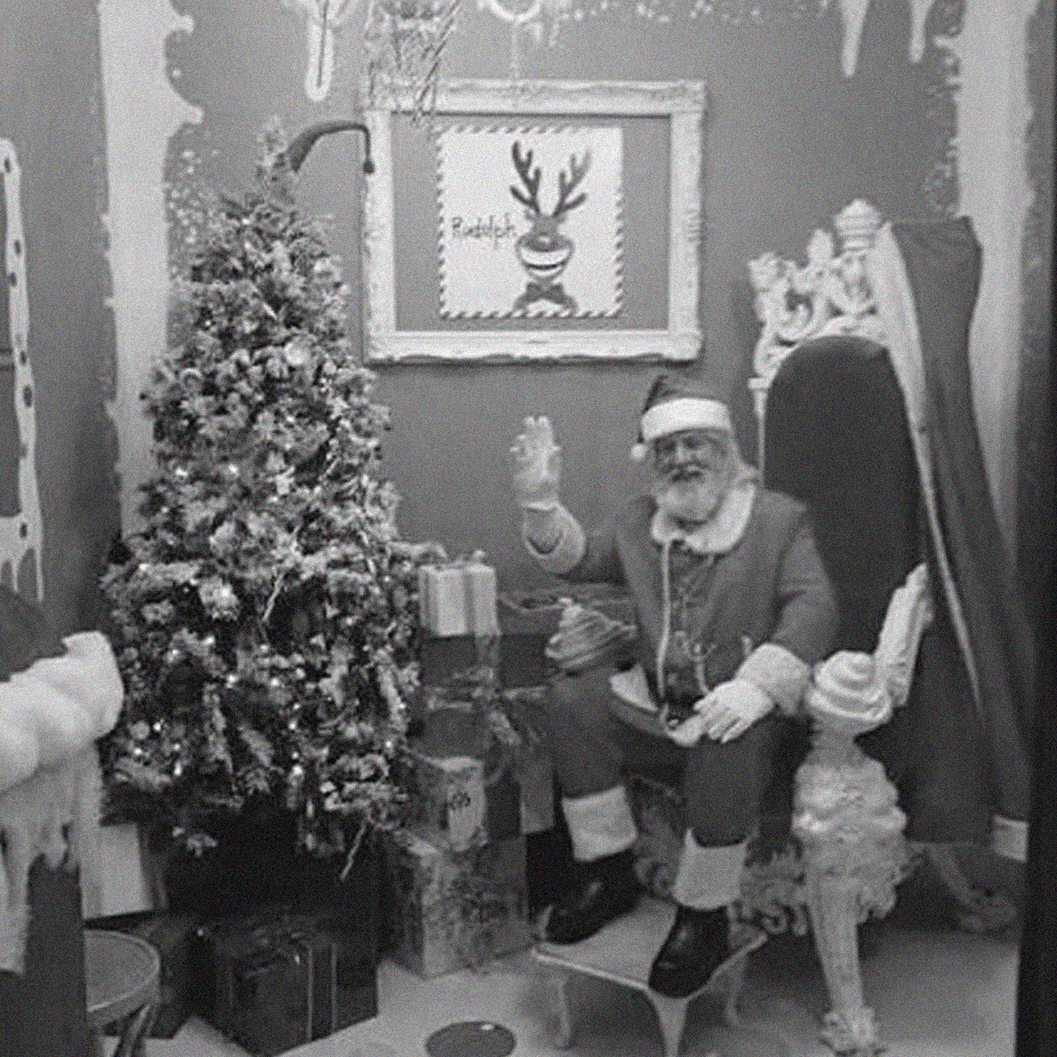 Santa's Grotto parade float at Arnotts with Father Christmas, woman in red coat, and child waving from decorated sleigh with Christmas baubles and garland
