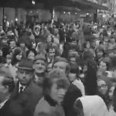 Black and white photograph of crowds gathered inside Arnotts, showcasing the bustling atmosphere of shoppers during the post-Christmas sale.