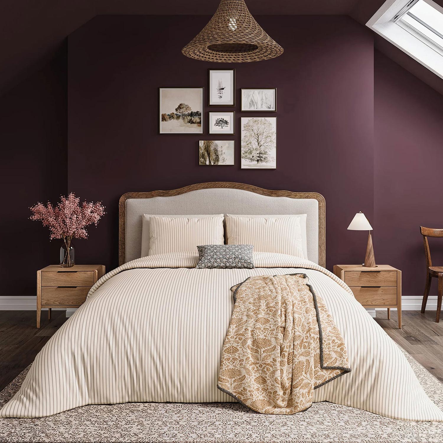 Cozy bedroom with a striped bedspread, purple accent wall, framed art, skylight, and wooden furniture.