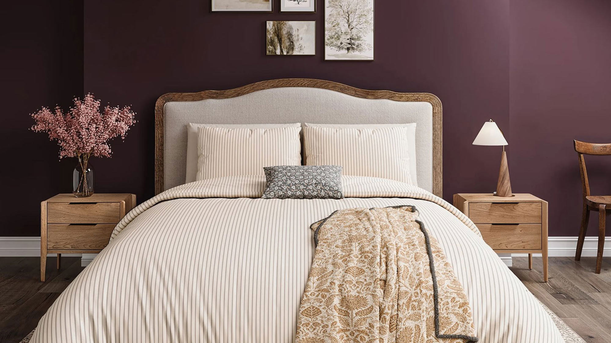Cozy bedroom with a striped bedspread, purple accent wall, framed art, skylight, and wooden furniture.