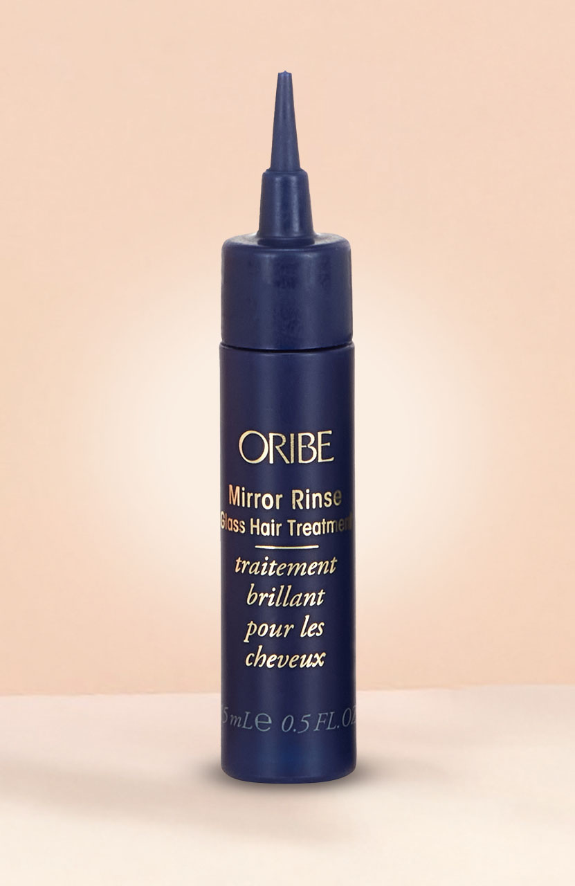 A gray canister of 'Modern Hairspray' by Sam McKnight on a light pink background.