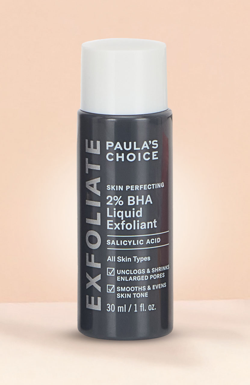 Tube of Loving Tan Bronze Shimmer Luminous Cream, dark shade, on a light pink background.