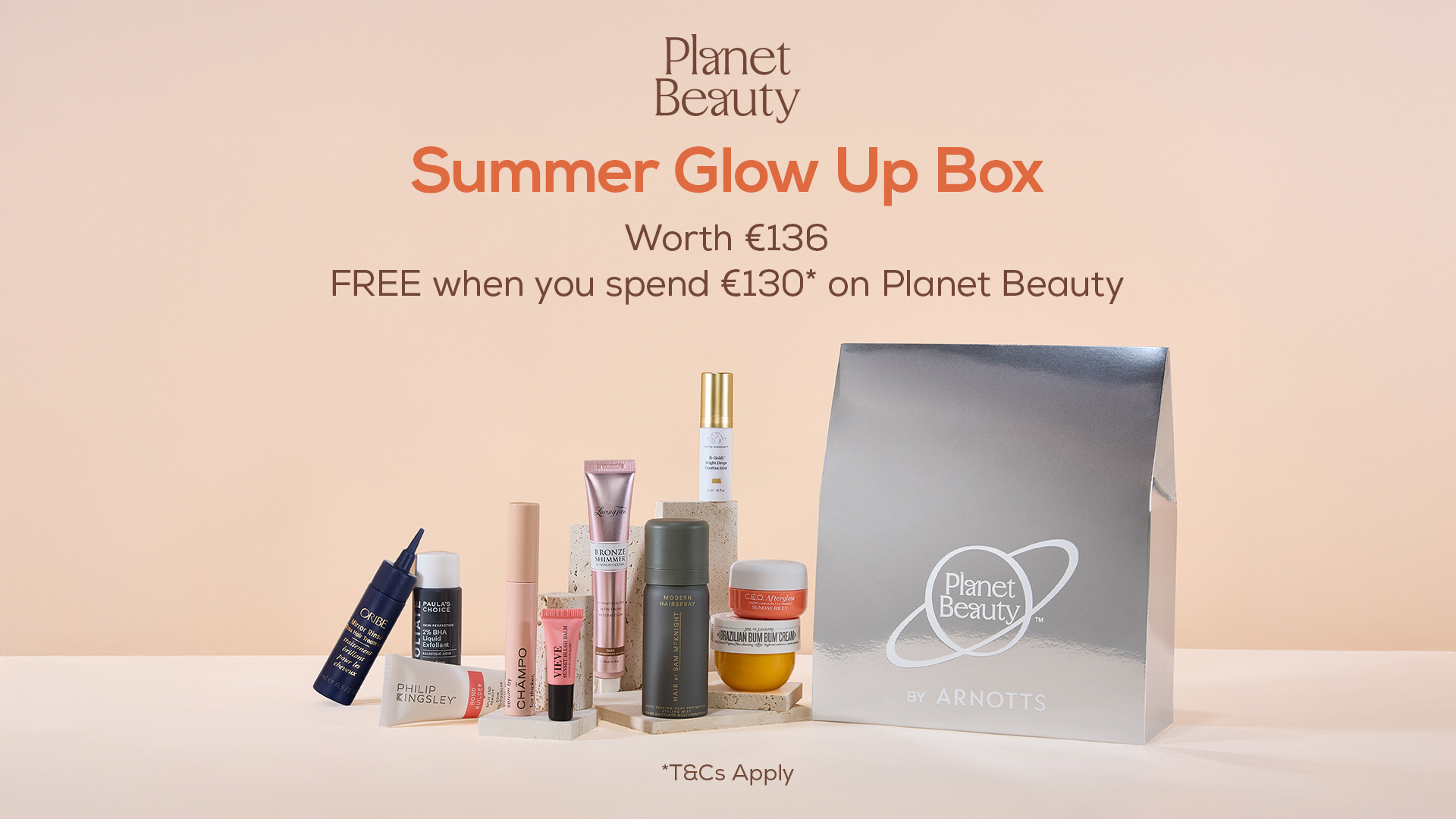 A collection of beauty products next to a silver box, promoting a 'Summer Glow Up Box' offer from Planet Beauty, free with a €130 purchase.