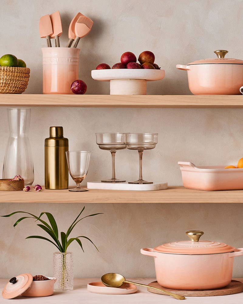 Kitchen shelves with pots, pans, and eggs on a tiled wall background.