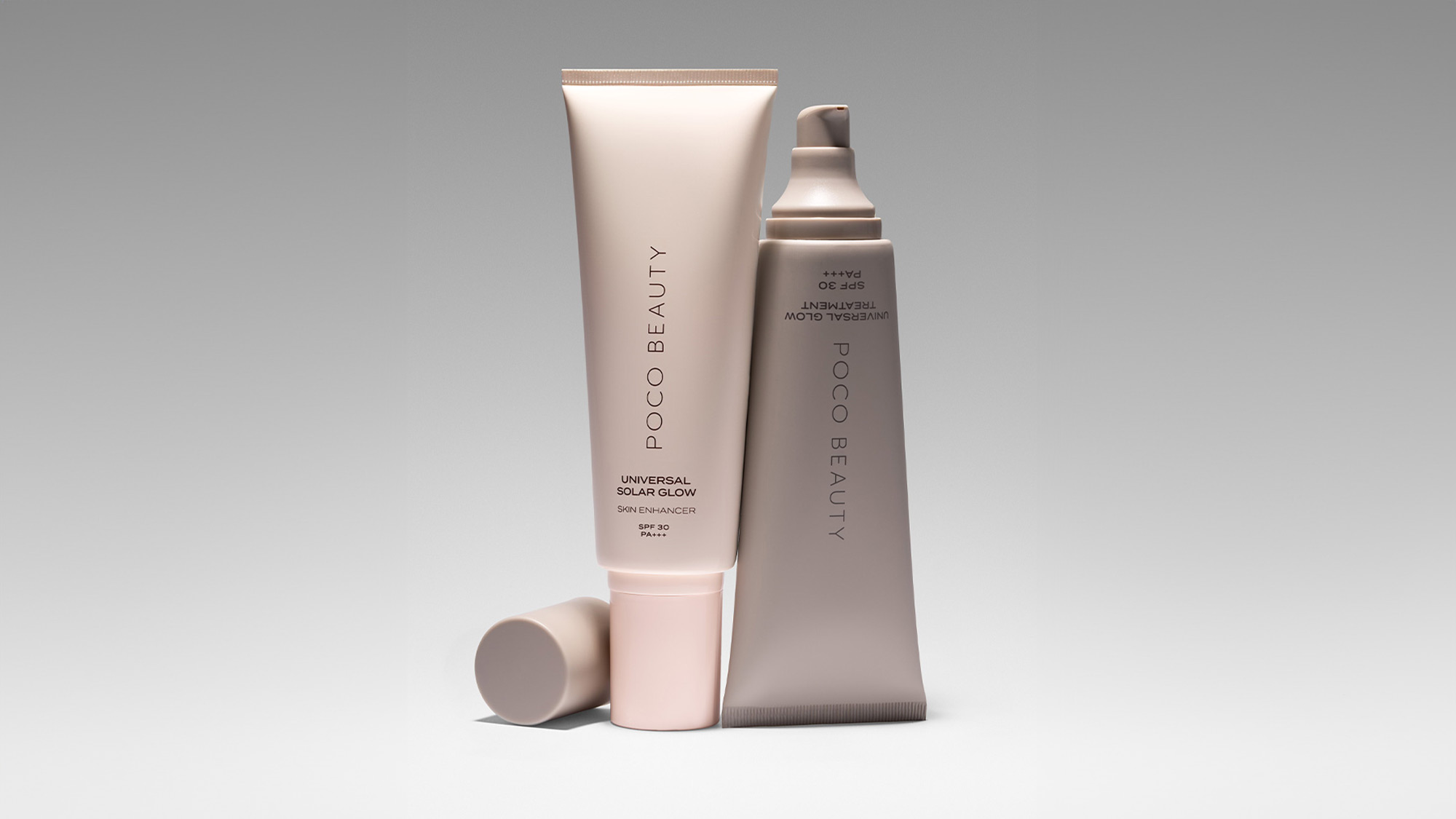 Two skincare tubes labeled 'Poco Beauty' against a gray background; one standing, one lying down.