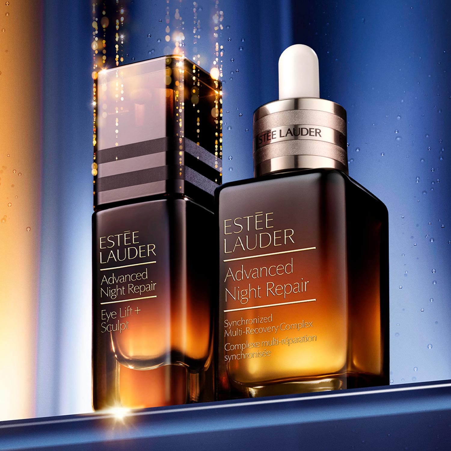 Two Estée Lauder Advanced Night Repair bottles on a reflective surface with a dark, gradient background.