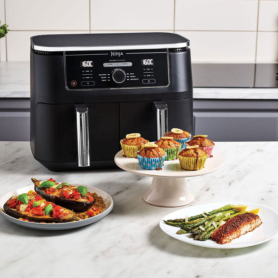 Three Ninja kitchen appliances on a blue background with text promoting summer savings, surrounded by colorful vegetables.