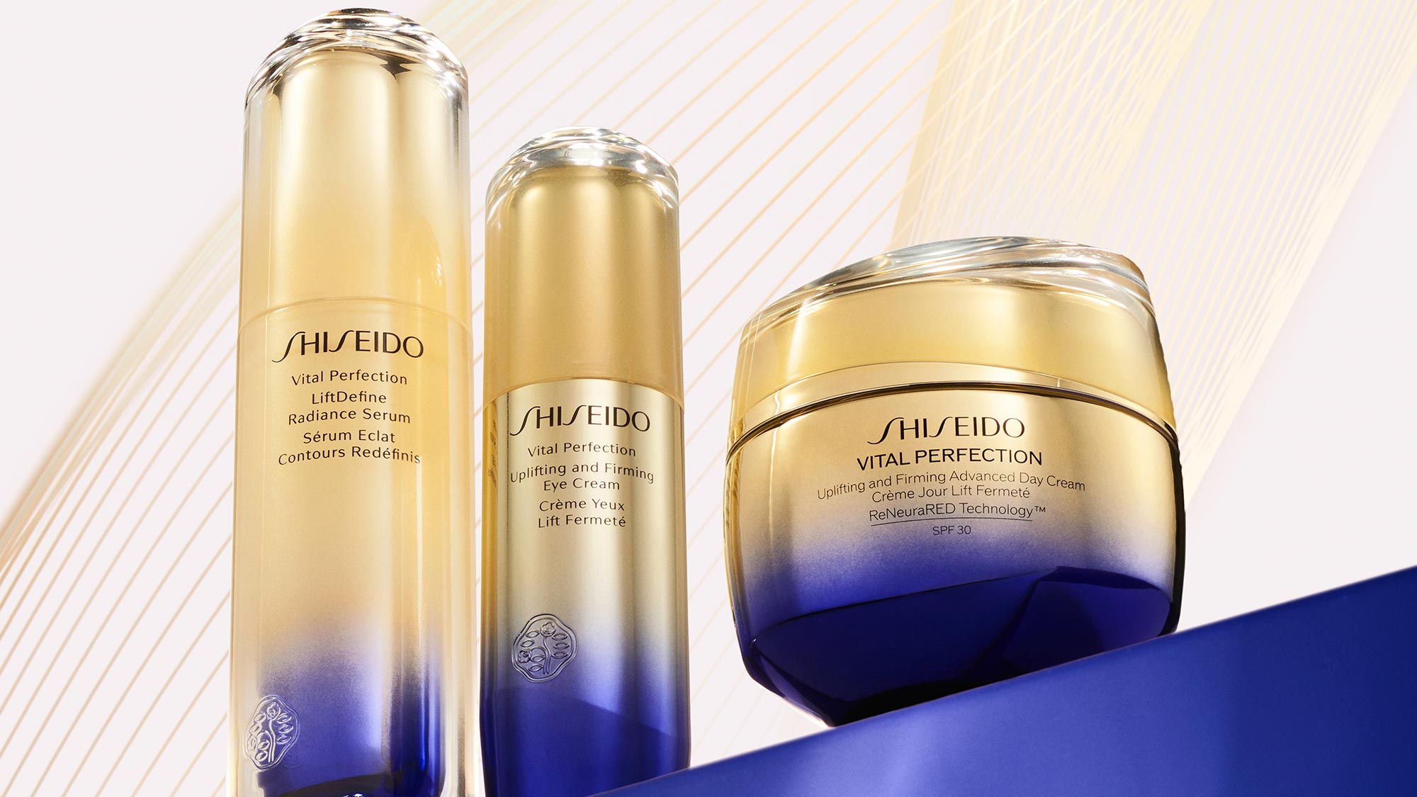 Shiseido Vital Perfection skincare bottles and a jar on a sleek, gradient background.