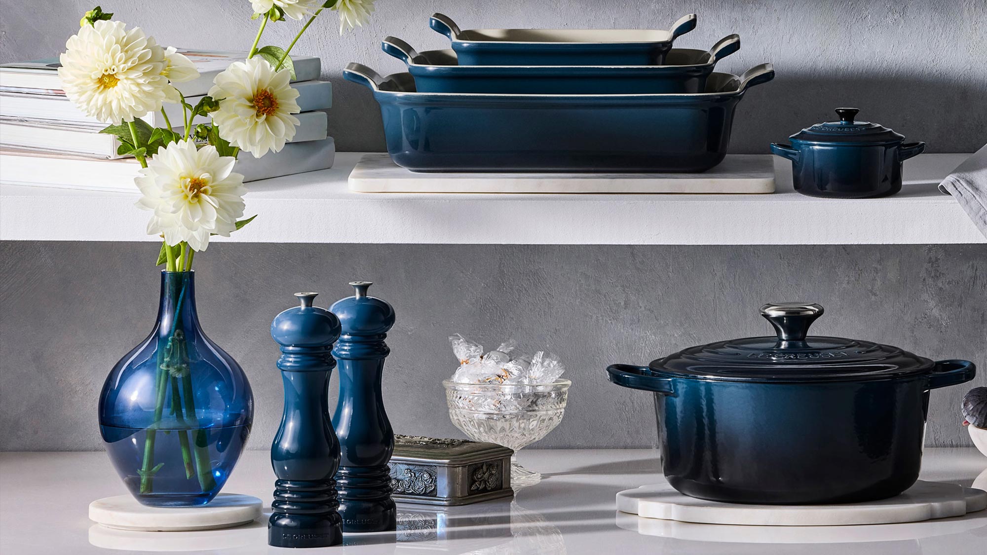 le creuset blue pots and pans on shelves