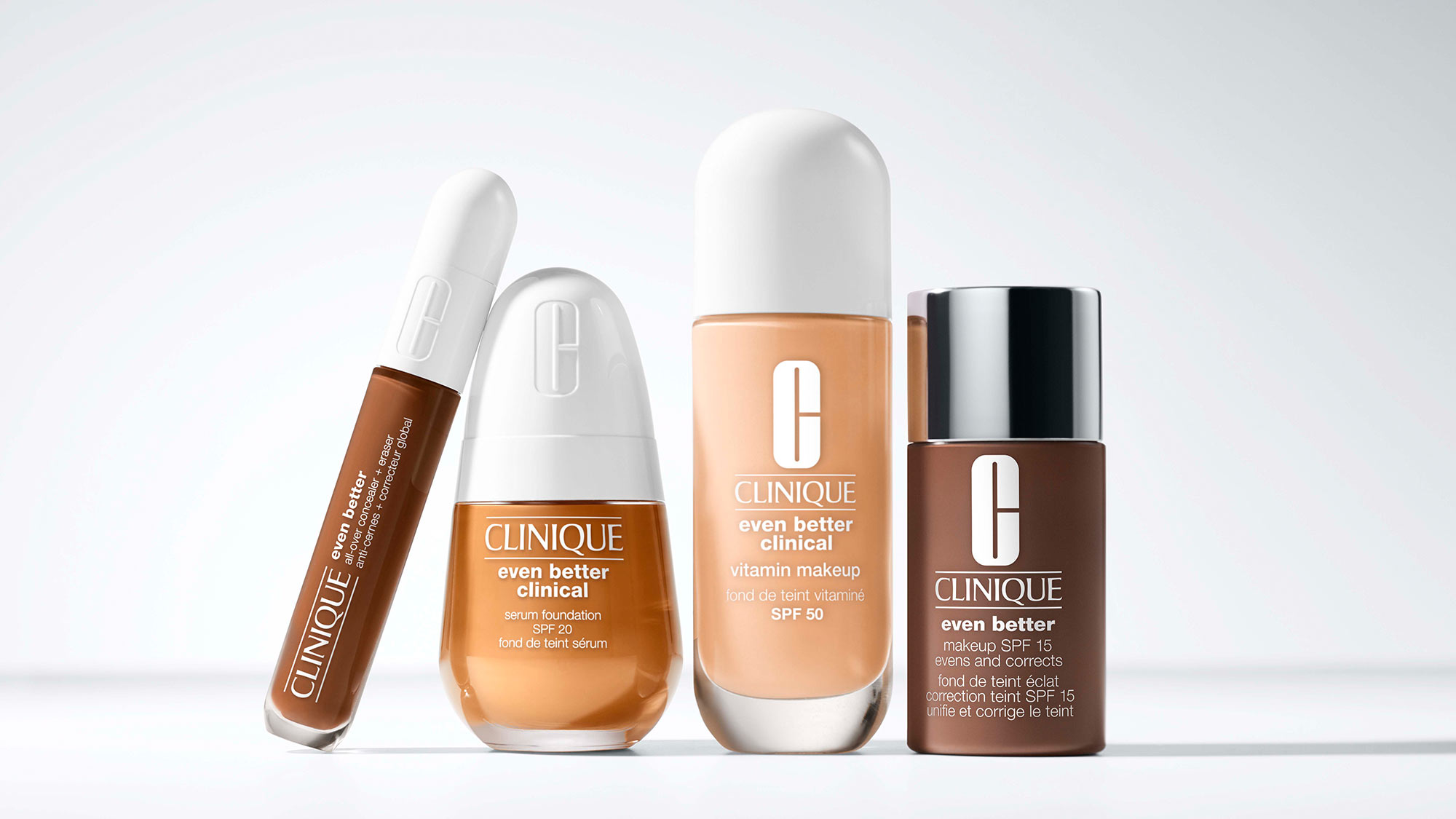 Four Clinique skincare products in varying shades aligned on a white surface.