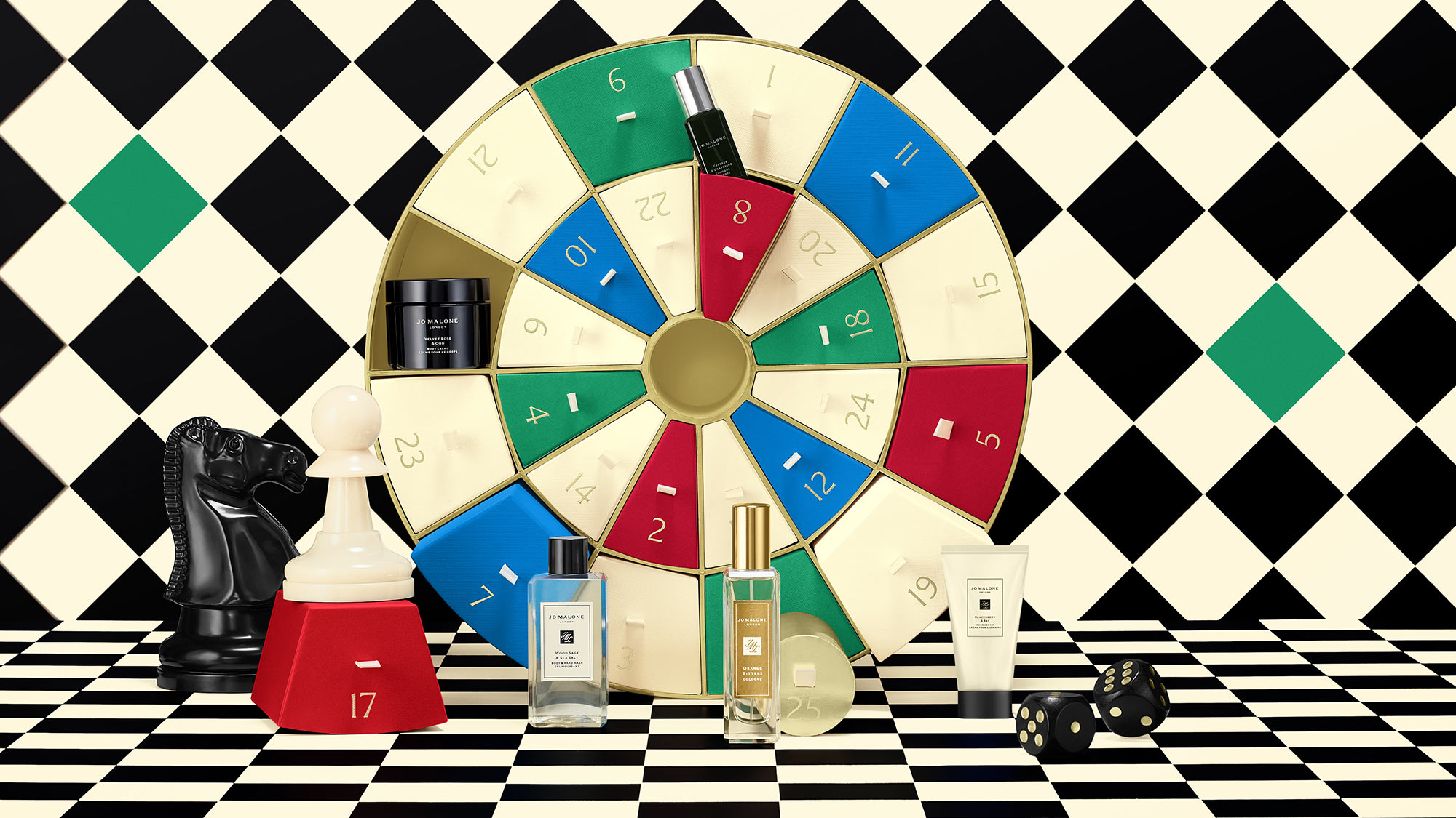 Perfume bottles displayed in front of a colorful wheel and chess piece, set against a black and white checkered background.