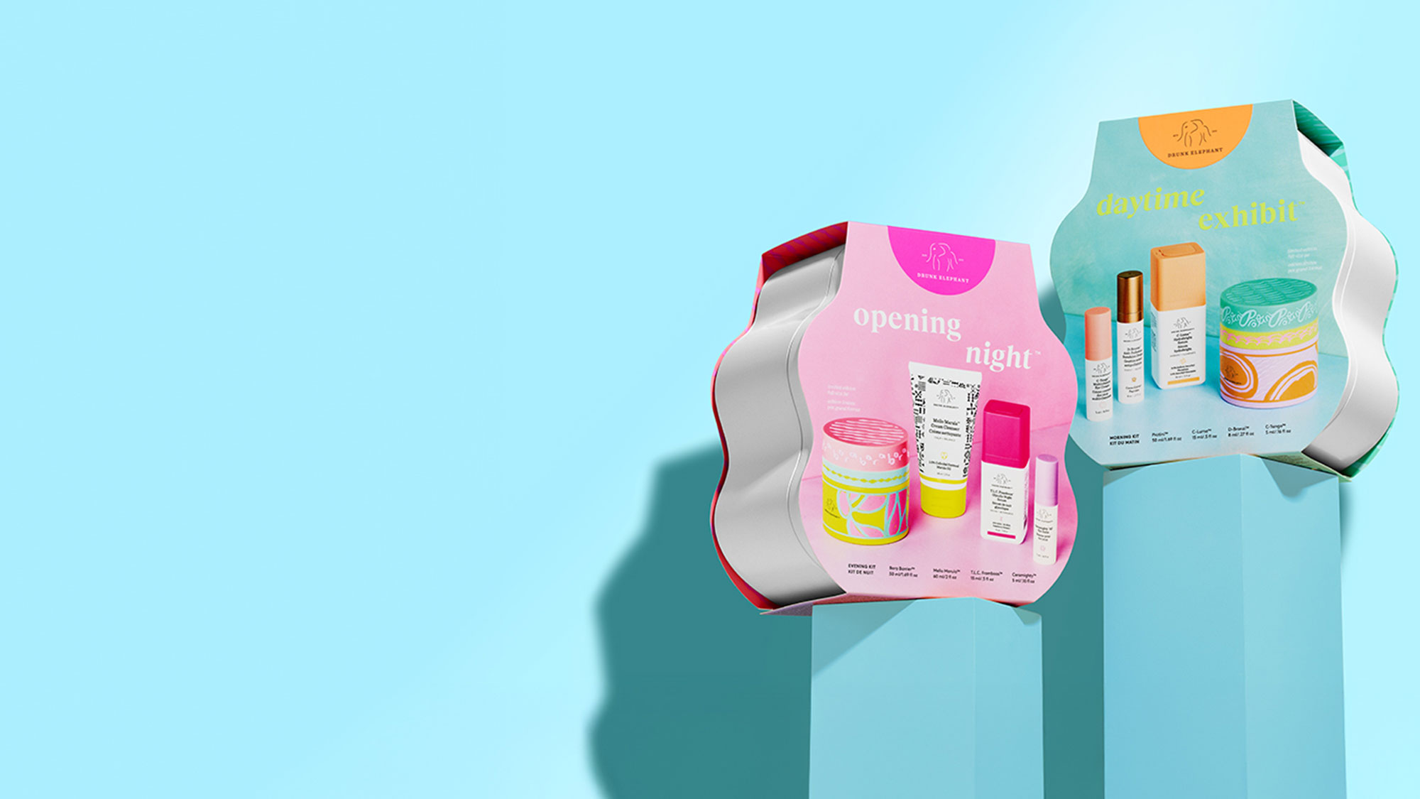 Two colorful product displays on pedestals against a light blue background.