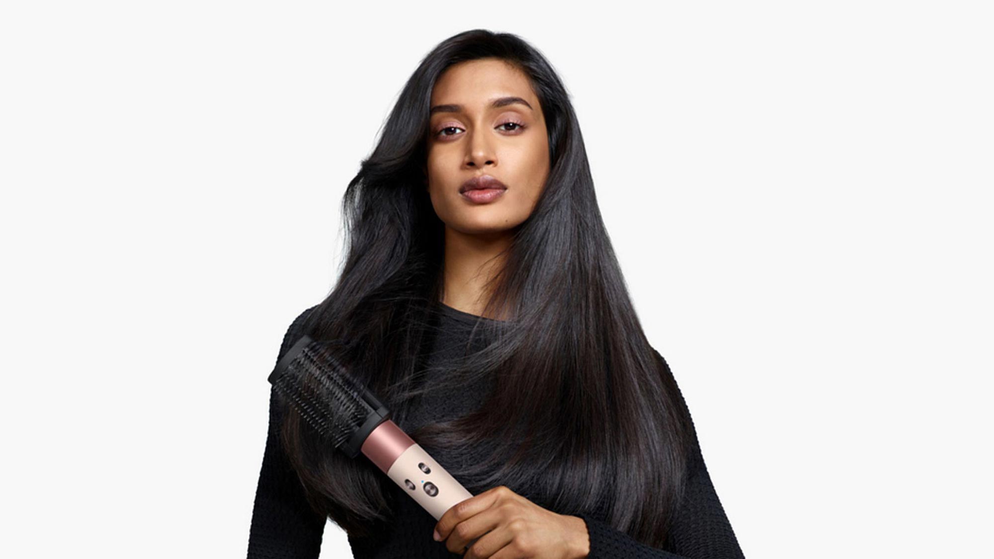 woman holds dyson in hand