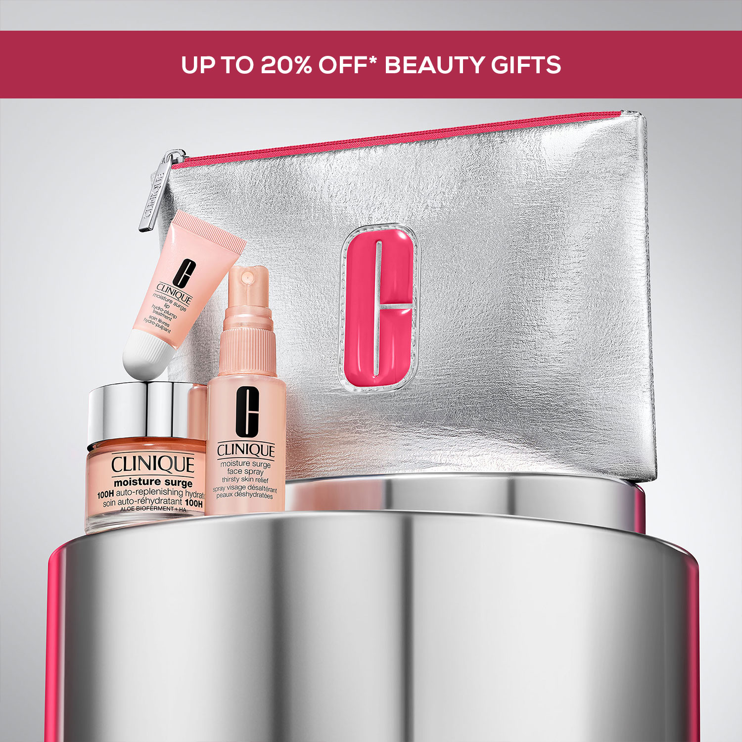 Cosmetic set with skincare products and a silver pouch with pink lining, branded 'Clinique,' displayed on a reflective surface.