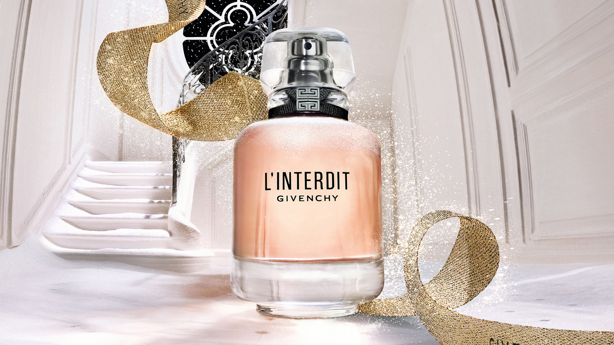 A perfume bottle labeled 'L'Interdit Givenchy' is set against a backdrop of an elegant staircase and swirling ribbon.