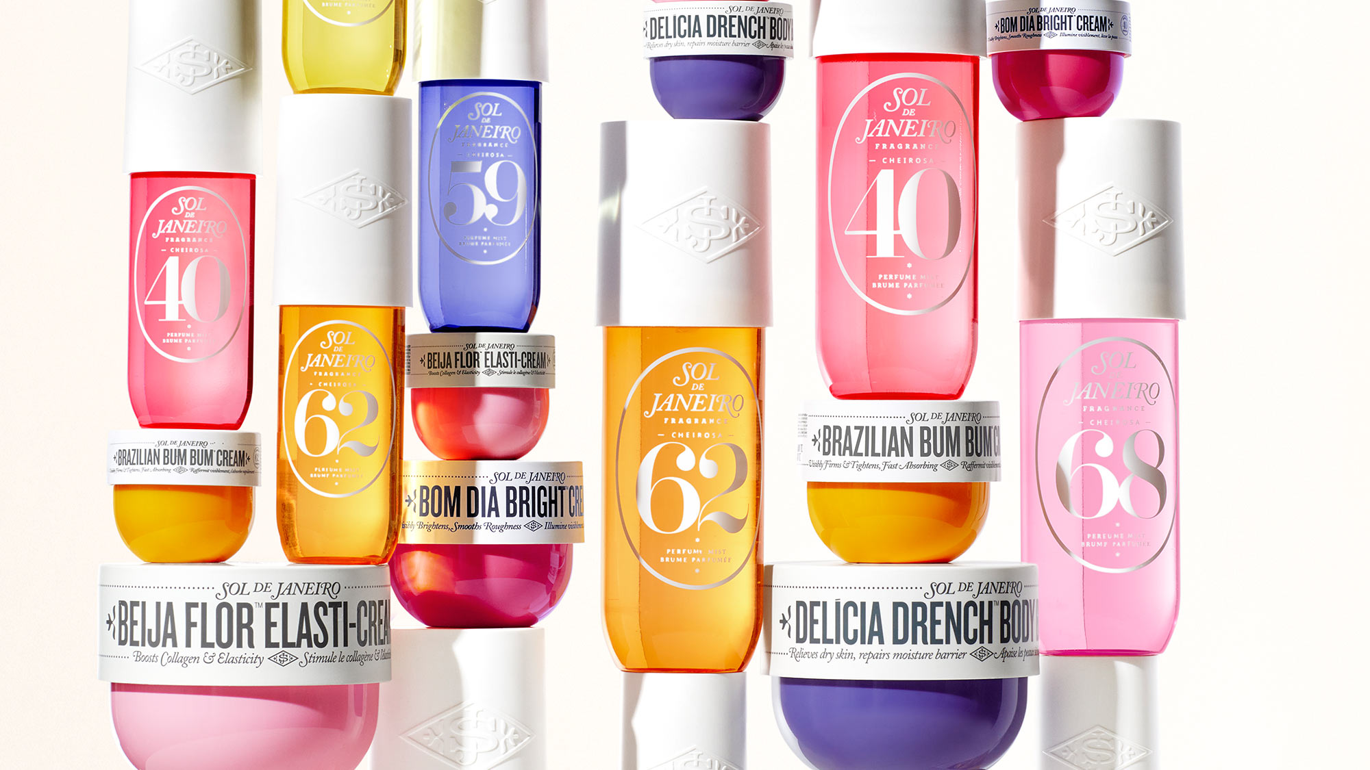 A collection of colorful Sol de Janeiro beauty products, including various creams and lotions, arranged in a stacked display.