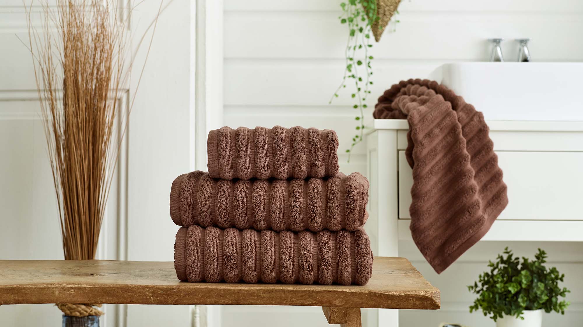 Brown towels on stool.