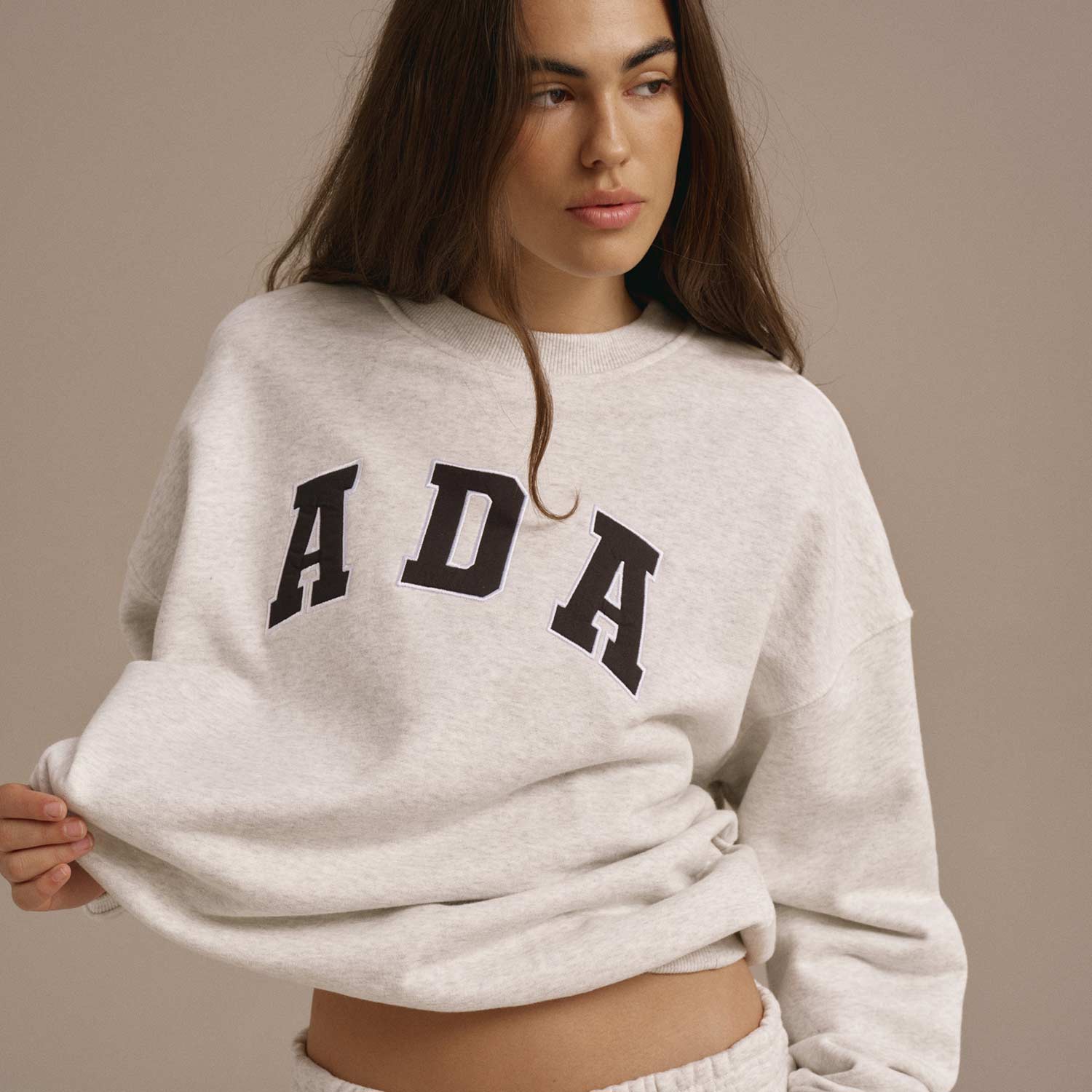 Woman wearing relaxed Adanola loungewear and trainers, ready for airport travel