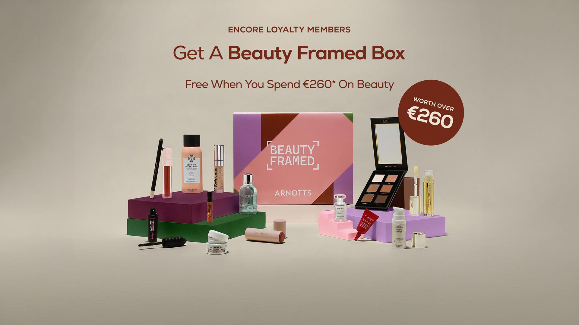 Beauty Framed Box promotion featuring cosmetics and skincare products arranged on coloured blocks, worth over €260
