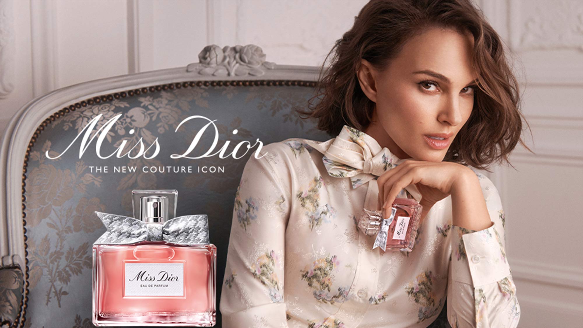 Woman holding a Miss Dior perfume bottle, with another bottle beside her. Text reads 'Miss Dior: The New Couture Icon.